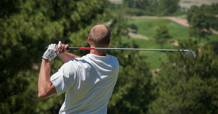 man swinging a golf club 